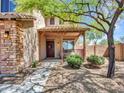 Inviting covered front porch offers a cozy seating area and views of the landscaped front yard at 12706 W Pasaro Dr, Peoria, AZ 85383