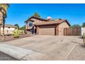 Side view of a two-story home with a two-car garage and a desert landscaped front yard at 13051 N 75Th Dr, Peoria, AZ 85381