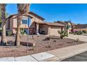 Inviting home with desert landscaping, two-car garage and a cozy front porch area at 13051 N 75Th Dr, Peoria, AZ 85381