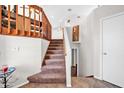 Carpeted staircase with wood railing leading to the upper level, showcasing neutral tones and clean design at 13051 N 75Th Dr, Peoria, AZ 85381