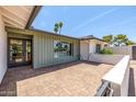 Private brick patio with view of the neighborhood through the picture window at 13601 N 50Th Pl, Scottsdale, AZ 85254