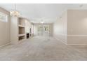 Spacious living room with a decorative fireplace, neutral carpet and abundant natural light at 1747 E Northern Ave # 104, Phoenix, AZ 85020