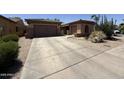 Charming single-Gathering home featuring a well-manicured front yard with xeriscape and a two-car garage at 2014 N 93Rd Dr, Phoenix, AZ 85037
