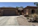 Charming single-Gathering home featuring a well-manicured front yard with xeriscape and a two-car garage at 2014 N 93Rd Dr, Phoenix, AZ 85037