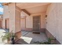 A welcoming covered front porch with security door and desert landscaping adds curb appeal to this charming home at 2061 E Flintlock Way, Chandler, AZ 85286