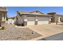 Side view of a cozy single Gathering house featuring a 2-car garage, desert landscaping, and driveway at 2101 S Meridian Rd # 199, Apache Junction, AZ 85120