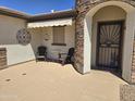 Comfortable porch area featuring stone accents, outdoor seating, and a shade awning at 2101 S Meridian Rd # 199, Apache Junction, AZ 85120