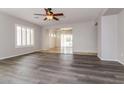 Open-concept living room with plantation shutters and views into the sun room at 23162 W Lasso Ln, Buckeye, AZ 85326