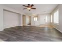 Spacious living room features wood-look floors, neutral paint, and ample natural light at 23162 W Lasso Ln, Buckeye, AZ 85326