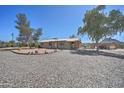 Cozy ranch home with gravel yard, mature trees, and covered parking at 2627 W Buckskin Trl, New River, AZ 85087