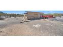 Shed featuring a garage and a gravel driveway at 2627 W Buckskin Trl, New River, AZ 85087