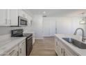 Modern kitchen featuring white cabinets, quartz countertops, and stainless steel appliances at 2728 W Redfield Rd, Phoenix, AZ 85053