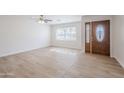 Bright and spacious living room featuring wood-look floors and a ceiling fan at 2728 W Redfield Rd, Phoenix, AZ 85053