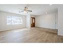 Bright and spacious living room featuring wood-look floors, a ceiling fan, and recessed lighting at 2728 W Redfield Rd, Phoenix, AZ 85053
