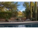 Beautiful backyard oasis featuring a pool, mature landscaping, and mountain views at 28897 N 94Th Pl, Scottsdale, AZ 85262