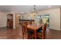 Open concept dining area with stained concrete floors and modern hanging light fixture at 3030 E Shangri La Rd, Phoenix, AZ 85028