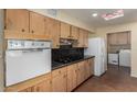 Galley style kitchen with vintage oven and lots of wooden cabinet space at 3030 E Shangri La Rd, Phoenix, AZ 85028