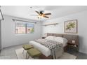 Bedroom with a plush bed, ceiling fan, and bright natural light from the large window at 3031 N Civic Center Plz # 317, Scottsdale, AZ 85251