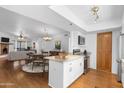 Open-concept kitchen and dining area with granite countertops, stainless steel appliances, and wood flooring at 3031 N Civic Center Plz # 317, Scottsdale, AZ 85251