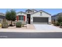 Charming single-story home with manicured landscaping, a two-car garage, and a well-maintained lawn at 30918 W Mulberry W Dr, Buckeye, AZ 85396