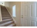 Welcoming entryway featuring a carpeted staircase and bright white door with modern hardware at 3236 E Chandler Blvd # 2003, Phoenix, AZ 85048