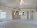 Spacious living room filled with natural light, featuring neutral carpet and open access to the kitchen at 3236 E Chandler Blvd # 2003, Phoenix, AZ 85048
