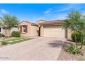 Attractive home with a brick-paved driveway, desert landscaping, and a convenient two-car garage at 32567 N 133Rd Ave, Peoria, AZ 85383