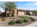 Well-maintained home with desert landscaping, a brick driveway, and a two-car garage at 32567 N 133Rd Ave, Peoria, AZ 85383