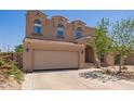 Charming two-story home featuring a red tile roof, three arched windows, and a spacious two-car garage at 3381 E Canary Way, Chandler, AZ 85286