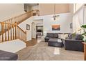 Open-concept living area with staircase, comfortable seating, and stylish decor, bathed in natural light at 3381 E Canary Way, Chandler, AZ 85286