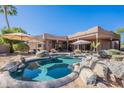 Beautiful backyard pool area showcasing desert landscaping, lounge chairs, and an outdoor dining space at 3405 E Knox Rd, Phoenix, AZ 85044
