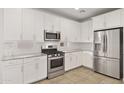 The renovated kitchen features stainless steel appliances, white cabinets, and granite countertops at 3847 S 63Rd Dr, Phoenix, AZ 85043