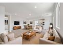 Bright, open living space seamlessly connects to dining and kitchen areas, ideal for modern living and entertaining at 3847 S 63Rd Dr, Phoenix, AZ 85043