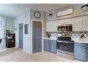 Well-lit kitchen featuring stainless steel appliances, sleek countertops, and modern backsplash at 4328 W Judson Dr, New River, AZ 85087