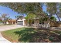 Beautiful single-story home with a well-maintained lawn, desert landscaping, and trees at 45 S Rita Ln, Chandler, AZ 85226