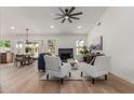 Bright and open living room featuring a fireplace, ceiling fan, and modern decor at 45 S Rita Ln, Chandler, AZ 85226