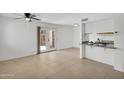Bright living room featuring tiled floors, a ceiling fan, and french doors to the backyard at 600 S Dobson Rd # 178, Mesa, AZ 85202