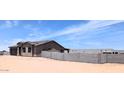 Charming single-story home featuring a neutral stucco exterior and a spacious, unfinished yard, awaiting landscaping at 6262 S Dean Rd, Buckeye, AZ 85326