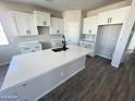 Bright kitchen featuring white cabinetry, a large island, and modern fixtures at 6262 S Dean Rd, Buckeye, AZ 85326