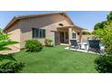 Well-maintained backyard with artificial grass, a shed, lounge seating, and mountain views at 6787 W Saddlehorn Rd, Peoria, AZ 85383