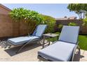 Lounge in style with comfortable seating in a perfectly arranged and landscaped backyard at 6787 W Saddlehorn Rd, Peoria, AZ 85383