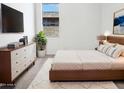 Cozy bedroom with modern furniture and a large window offering natural light at 7316 E Fledgling Dr, Scottsdale, AZ 85255