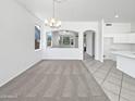 Spacious living area with neutral carpet and an open layout to the kitchen at 7316 E Fledgling Dr, Scottsdale, AZ 85255