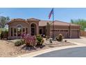 Well-maintained desert landscaping with vibrant cacti accents the home's exterior at 7762 E Russell Cir, Mesa, AZ 85207