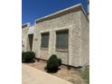 Exterior shot highlighting the textured stucco siding of a single-story home, complemented by well-placed shrubbery at 8110 N 31St Dr, Phoenix, AZ 85051