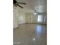 Open living room area with tile flooring and ceiling fans at 8110 N 31St Dr, Phoenix, AZ 85051