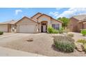 Inviting single-story home featuring desert landscaping, a covered entry, and an attached garage at 871 N Granada Dr, Chandler, AZ 85226