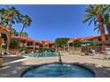 Relaxing community pool and hot tub surrounded by palm trees and comfortable lounge chairs at 9707 E Mountain View Rd # 1408, Scottsdale, AZ 85258