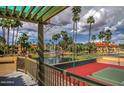A tennis court and picturesque fountain surrounded by palm trees and manicured landscaping create a relaxing outdoor atmosphere at 9707 E Mountain View Rd # 1408, Scottsdale, AZ 85258