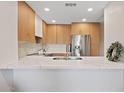 Sleek kitchen featuring stainless steel appliances, quartz countertops, and light wood cabinetry at 9708 E Via Linda Rd # 1350, Scottsdale, AZ 85258